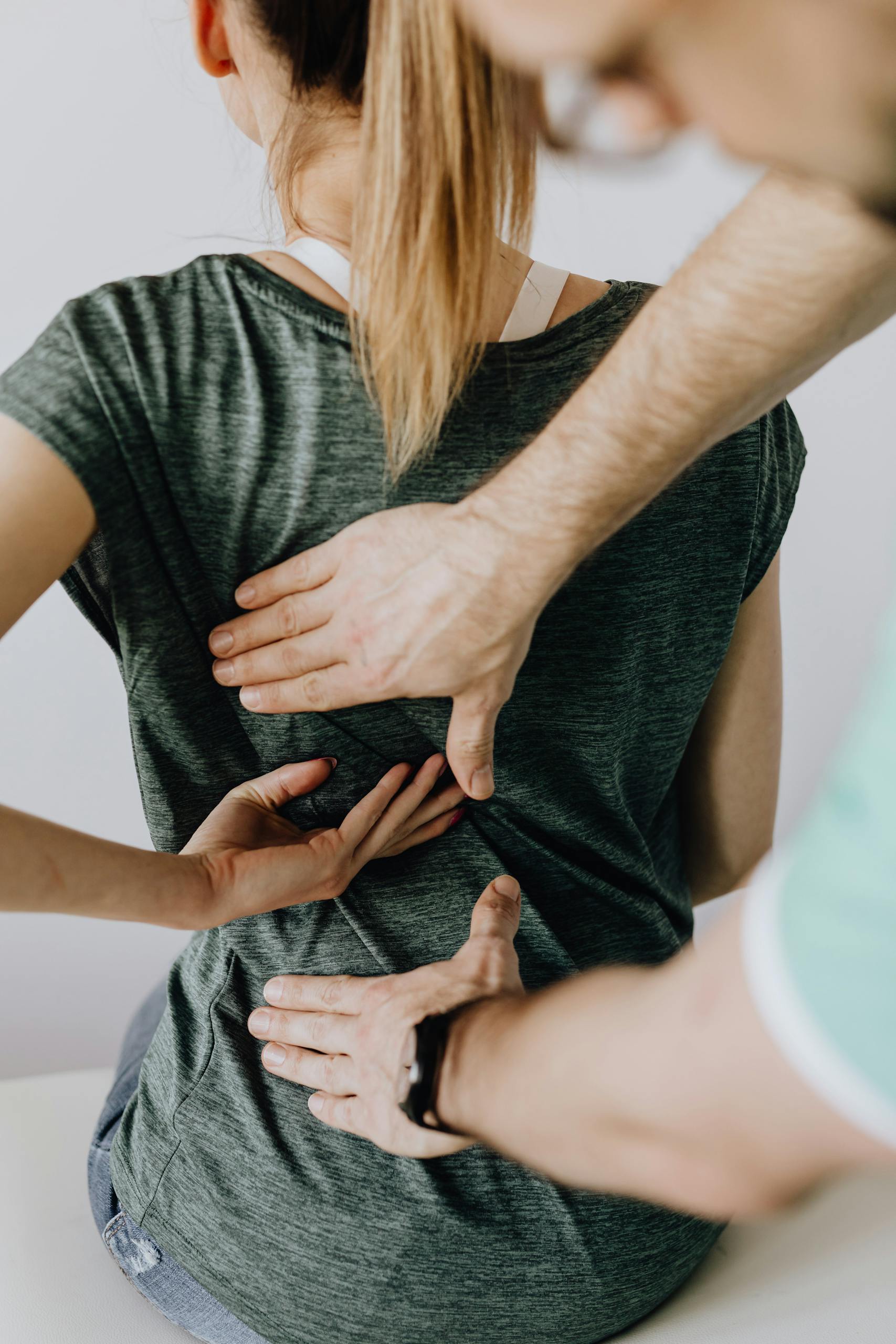 examining back of anonymous patient in clinic